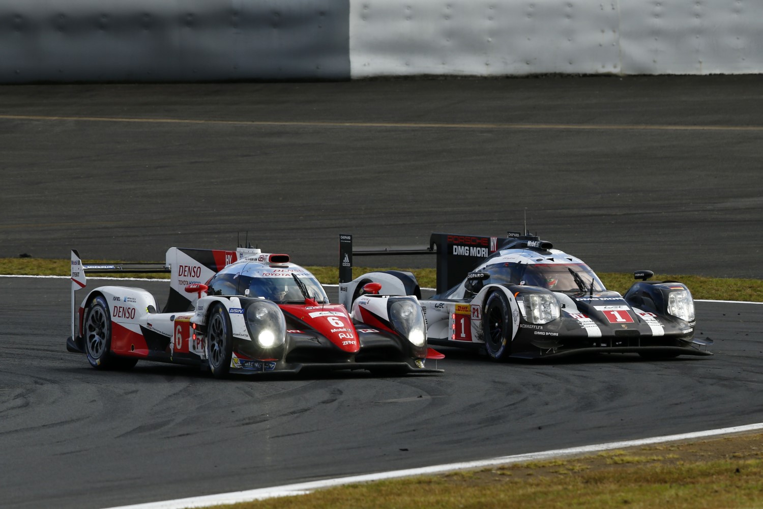 The winning Toyota passes the pole winning #1 Porsche