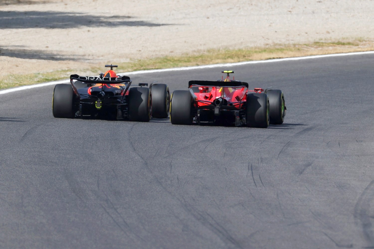 Max Verstappen of the Netherlands driving the (1) Oracle Red Bull Racing RB19 and Carlos Sainz of Spain driving (55) the Ferrari SF-23 battle for track position during the F1 Grand Prix of Italy at Autodromo Nazionale Monza on September 03, 2023 in Monza, Italy. (Photo by Ryan Pierse/Getty Images for Pirelli)