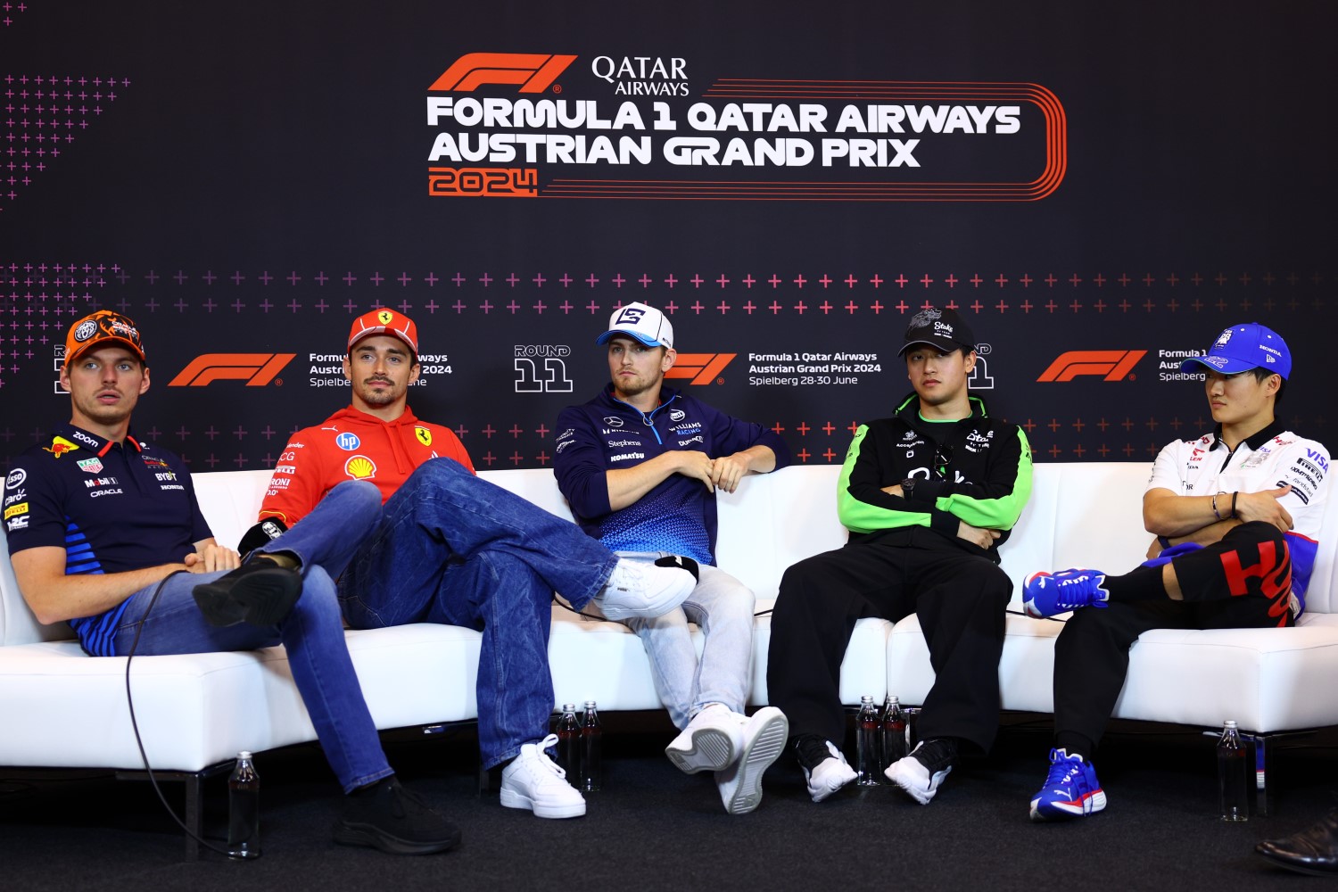(L to R) Max Verstappen of the Netherlands and Oracle Red Bull Racing, Charles Leclerc of Monaco and Ferrari, Logan Sargeant of United States and Williams, Zhou Guanyu of China and Stake F1 Team Kick Sauber and Yuki Tsunoda of Japan and Visa Cash App RB attend the Drivers Press Conference during previews ahead of the F1 Grand Prix of Austria at Red Bull Ring on June 27, 2024 in Spielberg, Austria. (Photo by Clive Rose/Getty Images) // Getty Images / Red Bull Content Pool