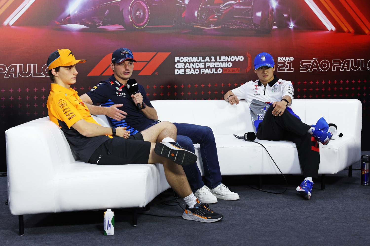 Oscar Piastri of Australia and McLaren, Max Verstappen of the Netherlands and Oracle Red Bull Racing and Yuki Tsunoda of Japan and Visa Cash App RB attend the Drivers Press Conference during previews ahead of the F1 Grand Prix of Brazil at Autodromo Jose Carlos Pace on October 31, 2024 in Sao Paulo, Brazil. (Photo by Lars Baron/Getty Images) // Getty Images / Red Bull Content Pool