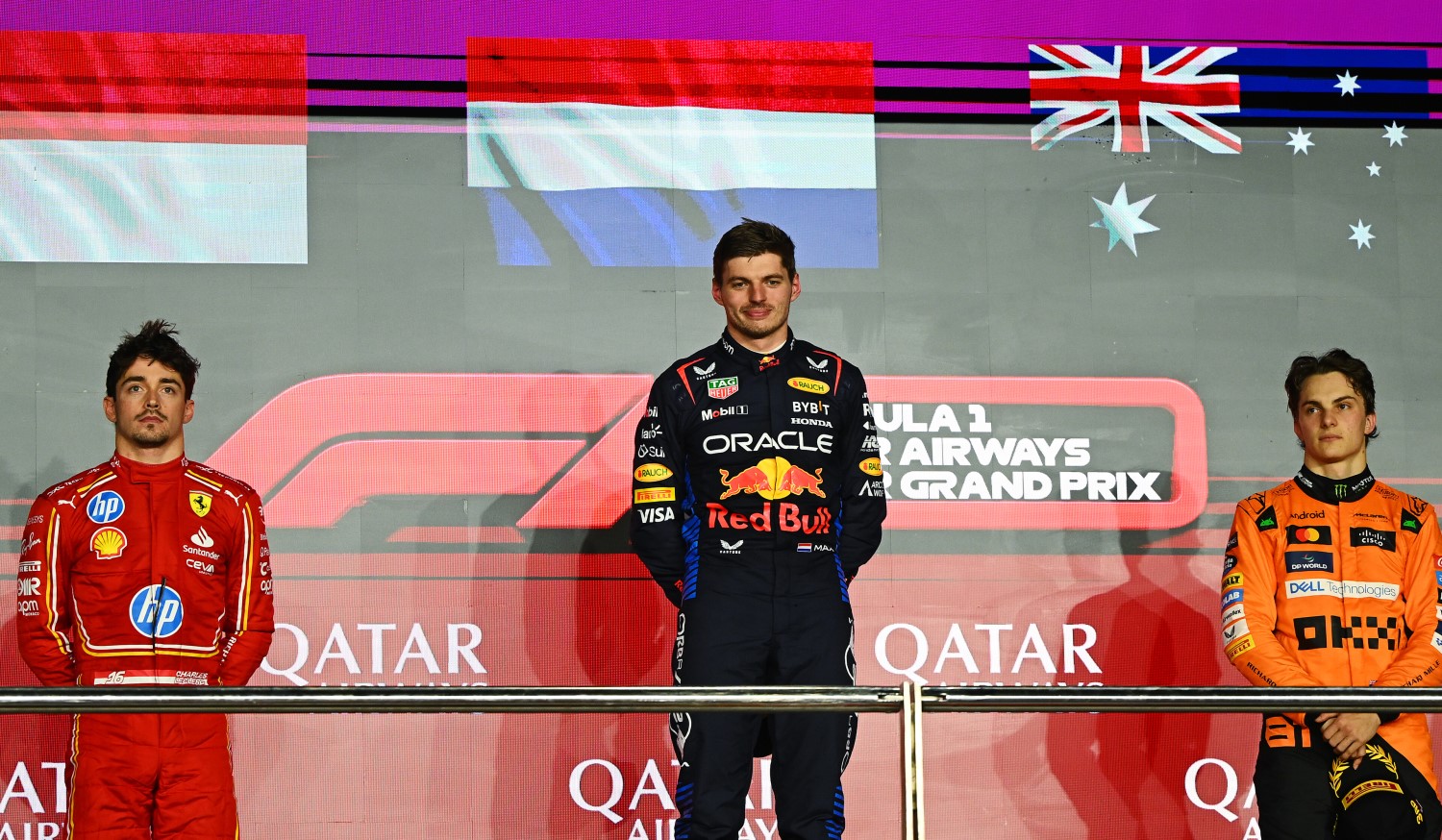 Race winner Max Verstappen of the Netherlands and Oracle Red Bull Racing (C), Second placed Charles Leclerc of Monaco and Ferrari (L) and Third placed Oscar Piastri of Australia and McLaren (R) stand on the podium during the F1 Qatar GP at Lusail International Circuit on December 01, 2024 in Lusail City, Qatar. (Photo by Clive Mason/Getty Images) // Getty Images / Red Bull Content Pool