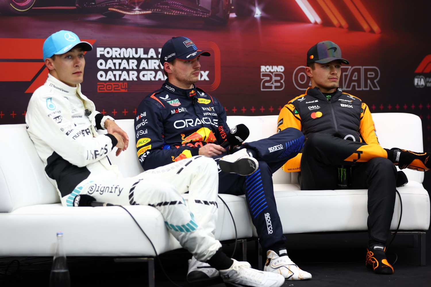 Pole position qualifier Max Verstappen of the Netherlands and Oracle Red Bull Racing, Second placed qualifier George Russell of Great Britain and Mercedes, and Third placed qualifier Lando Norris of Great Britain and McLaren attend the press conference after qualifying ahead of the F1 Grand Prix of Qatar at Lusail International Circuit on November 30, 2024 in Lusail City, Qatar. (Photo by Bryn Lennon/Getty Images) // Getty Images / Red Bull Content Pool