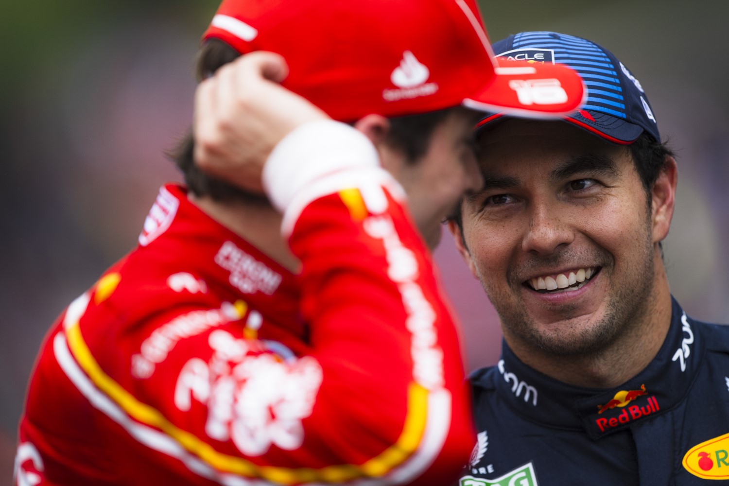 Third placed qualifier Sergio Perez of Mexico and Oracle Red Bull Racing and Second placed qualifier Charles Leclerc of Monaco and Ferrari talk in parc ferme during qualifying ahead of the F1 Grand Prix of Belgium at Circuit de Spa-Francorchamps on July 27, 2024 in Spa, Belgium. (Photo by Rudy Carezzevoli/Getty Images) // Getty Images / Red Bull Content Pool