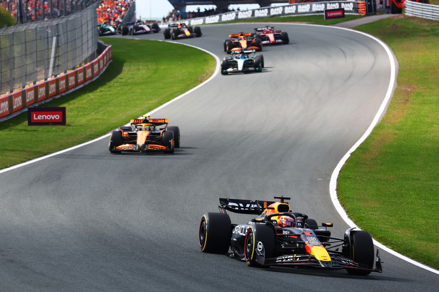 Max Verstappen of the Netherlands driving the (1) Oracle Red Bull Racing RB20 leads Lando Norris of Great Britain driving the (4) McLaren MCL38 Mercedes at the start during the F1 Grand Prix of Netherlands at Circuit Zandvoort on August 25, 2024 in Zandvoort, Netherlands. (Photo by Joe Portlock/Getty Images) // Getty Images / Red Bull Content Pool //