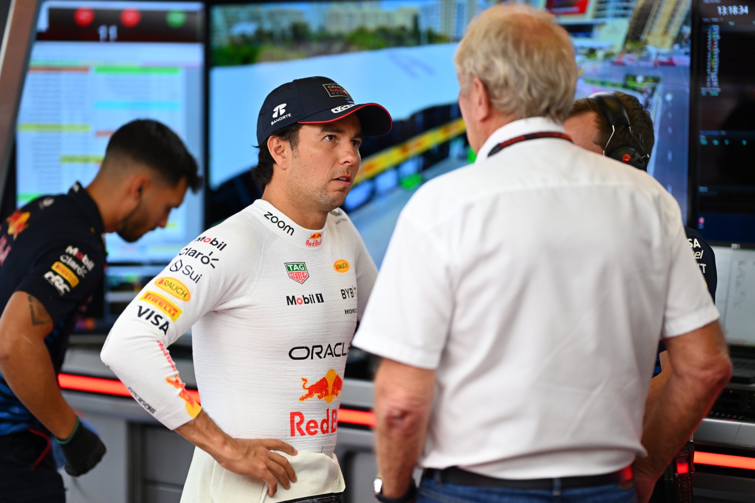 Sergio Perez of Mexico and Oracle Red Bull Racing talks with Oracle Red Bull Racing Team Consultant Dr Helmut Marko in the garage during practice ahead of the F1 Grand Prix of Azerbaijan at Baku City Circuit on September 13, 2024 in Baku, Azerbaijan. (Photo by Dan Mullan/Getty Images)