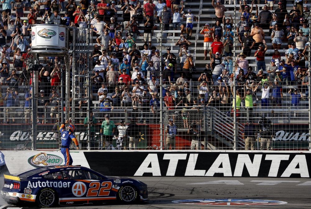 Joey Logano celebrates his Quaker State 400 win at Atlanta