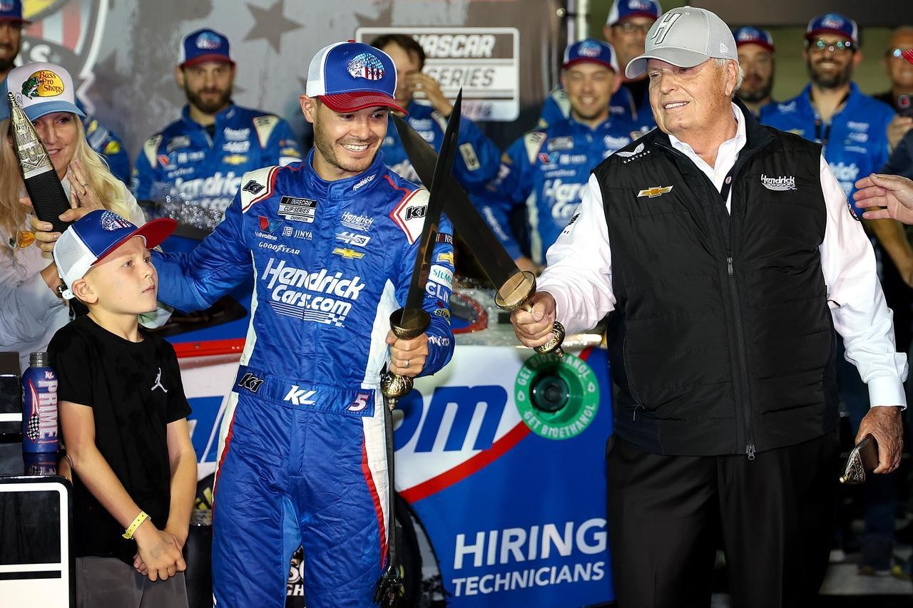 America's Night Race winner Kyle Larson (left) crosses BMS Gladiator Swords with his team owner Rick Hendrick in Victory Lane Saturday night at Bristol Motor Speedway.