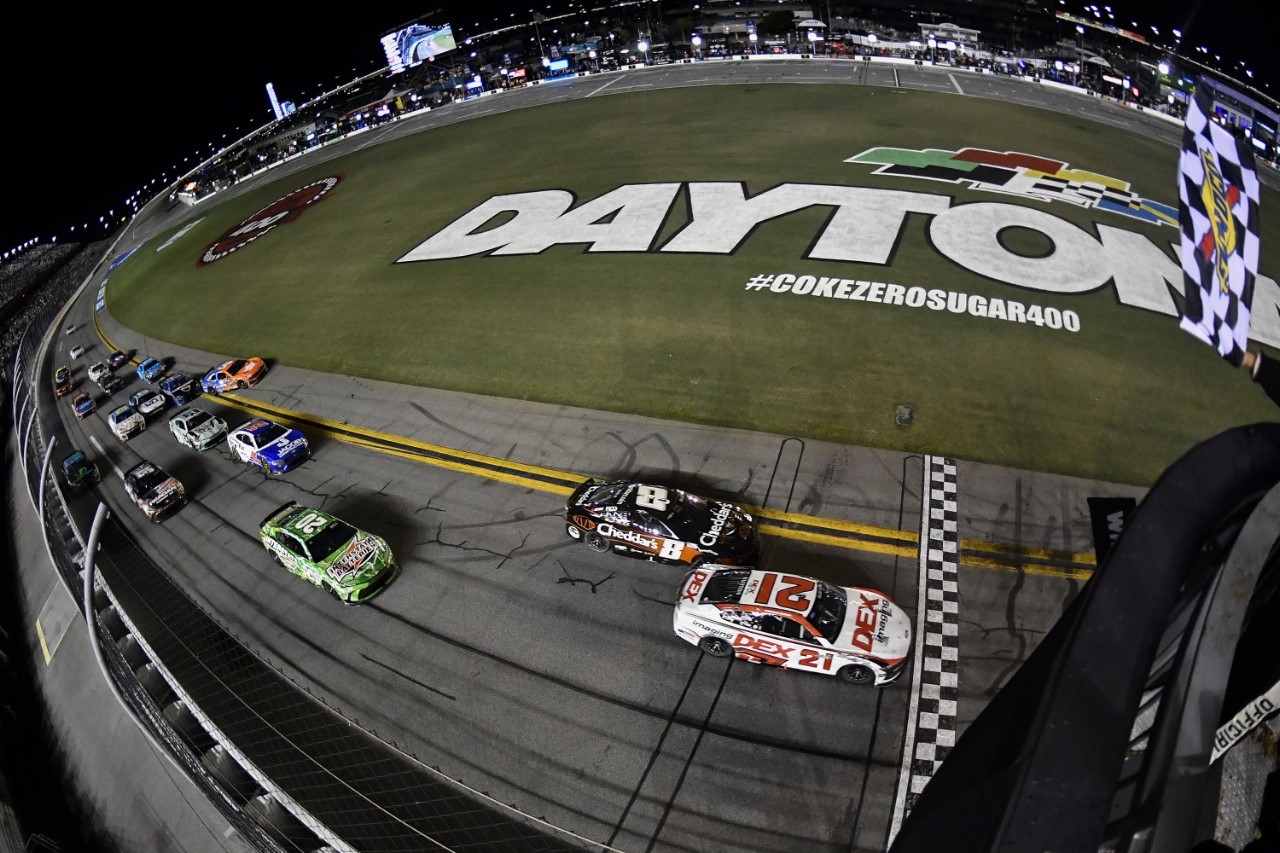 Harrison Burton, driver of the #21 DEX Imaging Ford, takes the checkered flag to win the NASCAR Cup Series Coke Zero Sugar 400 at Daytona International Speedway on August 24, 2024 in Daytona Beach, Florida. (Photo by Logan Riely/Getty Images)