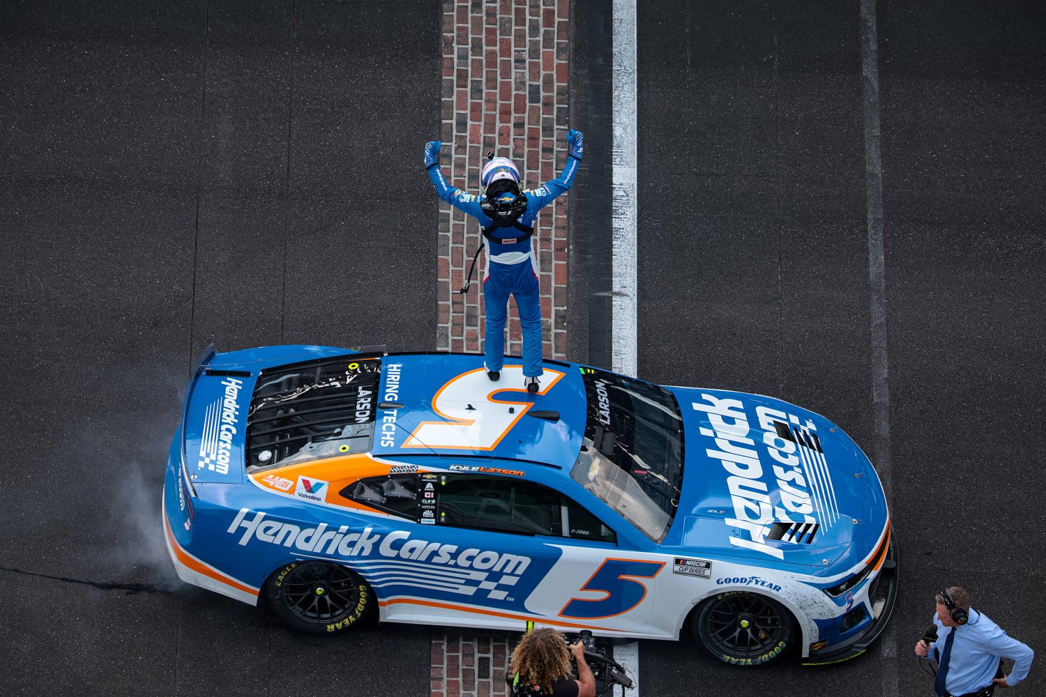 Kyle Larson, driver of the #5 HendrickCars.com Chevrolet, celebrates after winning the NASCAR Cup Series Brickyard 400 at Indianapolis Motor Speedway on July 21, 2024 in Indianapolis, Indiana. (Photo by James Gilbert/Getty Images)