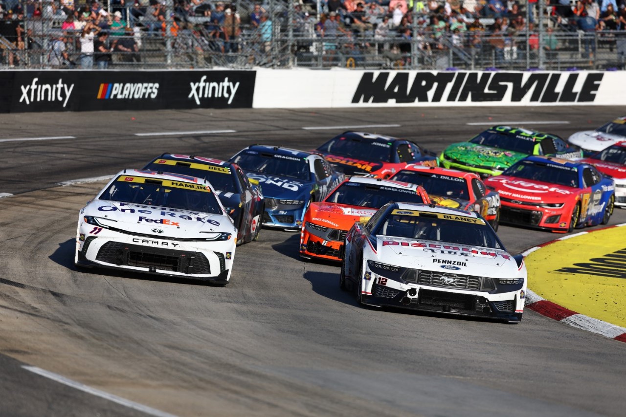 Denny Hamlin, driver of the #11 FedEx One Rate Toyota, and Ryan Blaney, driver of the #12 Discount Tire Ford, race during the NASCAR Cup Series Xfinity 500 at Martinsville Speedway on November 03, 2024 in Martinsville, Virginia. (Photo by David Jensen/Getty Images for NASCAR)