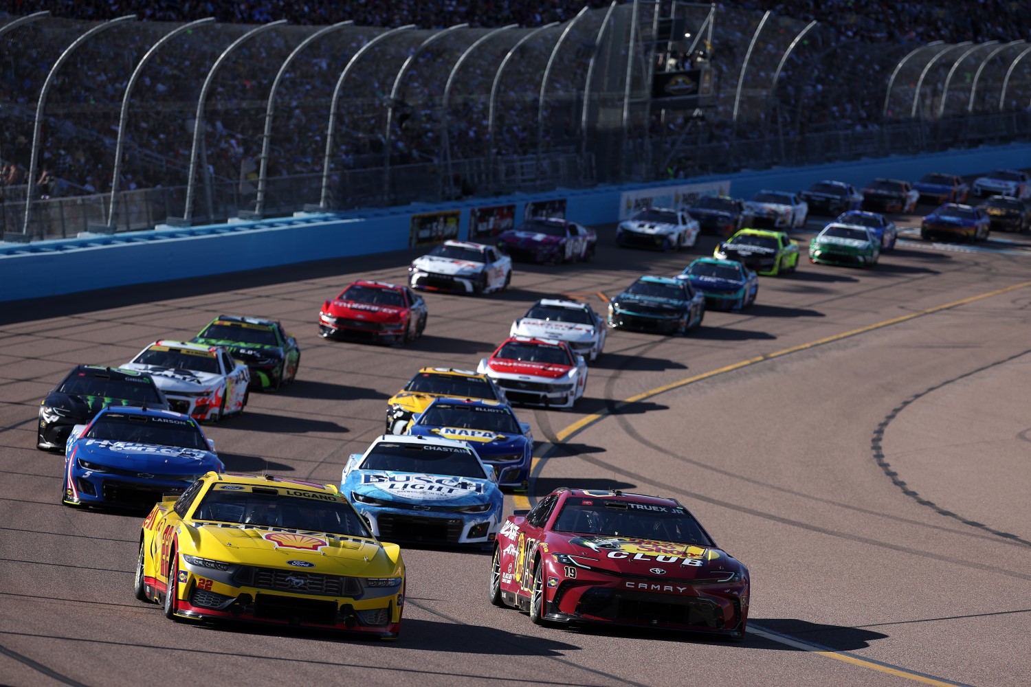 Martin Truex Jr., driver of the #19 Bass Pro Shops Toyota, and Joey Logano, driver of the #22 Shell Pennzoil Ford, lead the field during the NASCAR Cup Series Championship Race at Phoenix Raceway on November 10, 2024 in Avondale, Arizona. (Photo by James Gilbert/Getty Images)