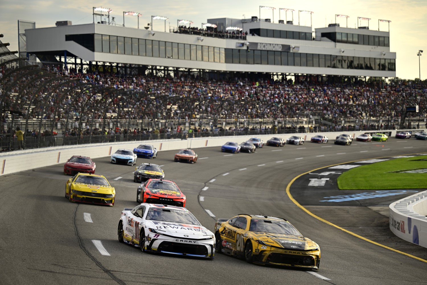 Denny Hamlin, driver of the #11 FedEx Rewards Toyota, and Christopher Bell, driver of the #20 DEWALT Carpentry Solutions Toyota, race during the NASCAR Cup Series Cook Out 400 at Richmond Raceway on August 11, 2024 in Richmond,