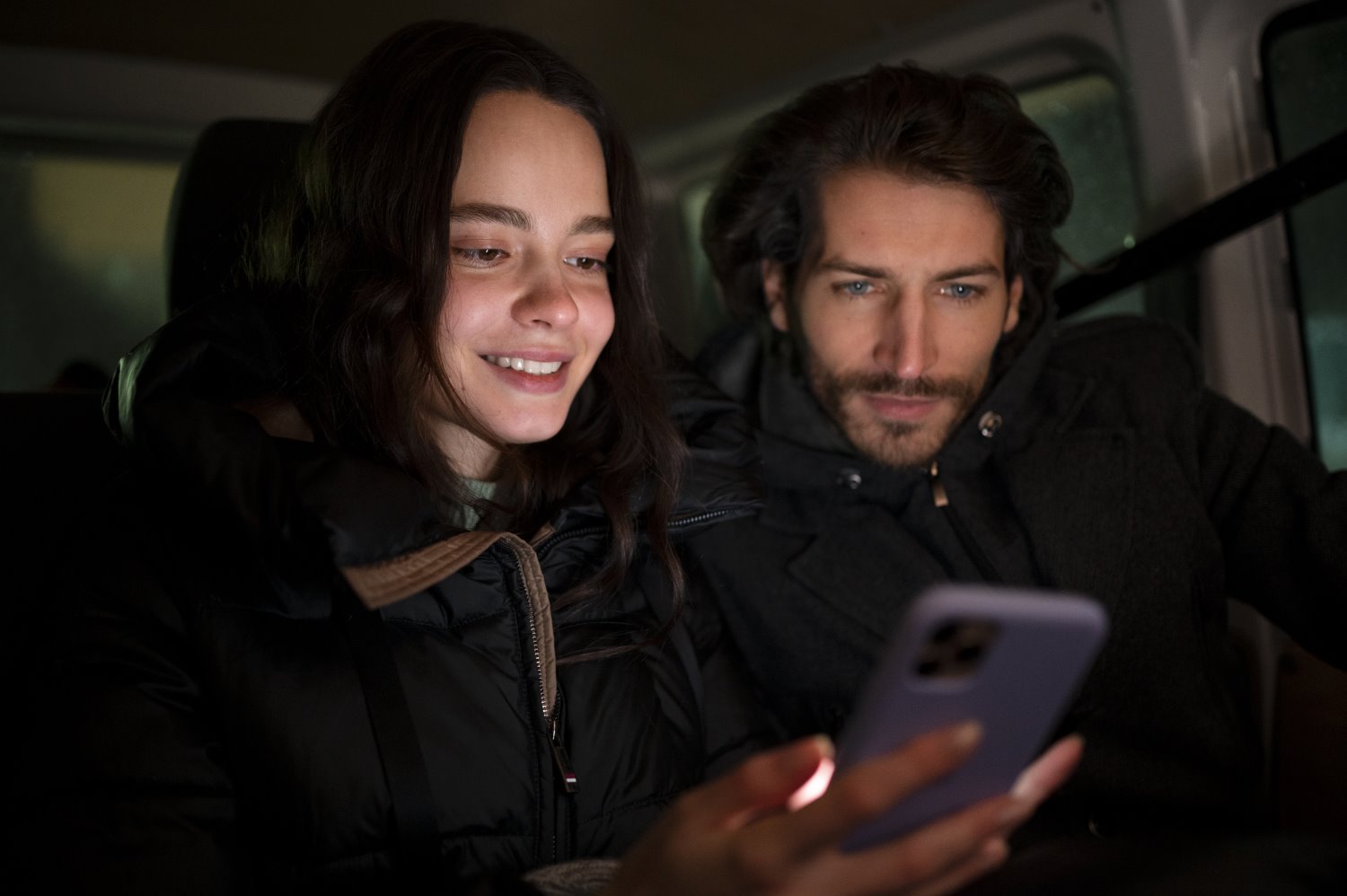 Couple watching ITV in rear seat of car. Designed by Freepik www.freepik.com