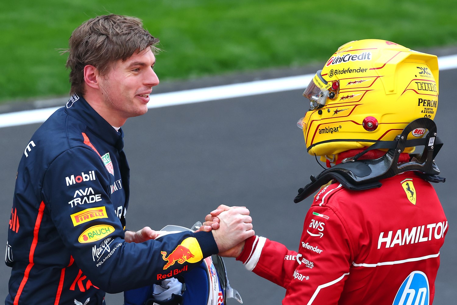 Third placed Max Verstappen of the Netherlands and Oracle Red Bull Racing and Sprint winner Lewis Hamilton of Great Britain and Scuderia Ferrari congratulate each other in parc ferme during the Sprint ahead of the F1 Grand Prix of China at Shanghai International Circuit on March 22, 2025 in Shanghai, China. (Photo by Clive Rose/Getty Images) // Getty Images / Red Bull Content Pool