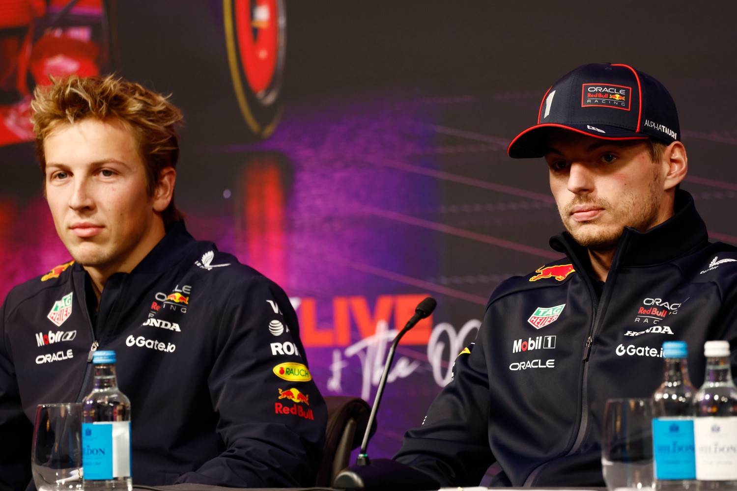 Liam Lawson of New Zealand and Oracle Red Bull Racing and Max Verstappen of the Netherlands and Oracle Red Bull Racing look on during a press conference prior to F1 75 Live at InterContinental London O2 on February 18, 2025 in London, England. (Photo by Zak Mauger/Getty Images) // Getty Images / Red Bull Content Pool //