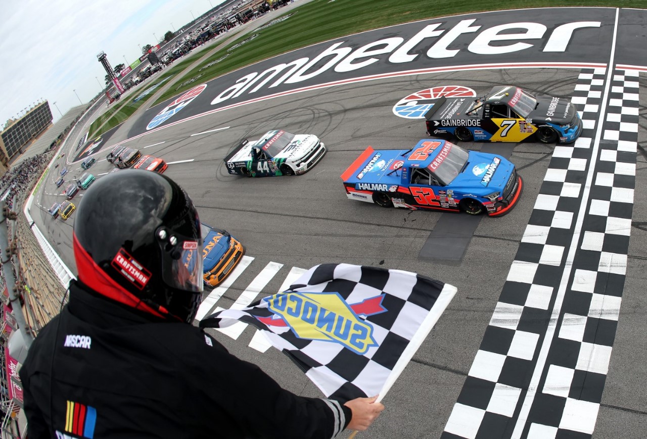 Kyle Busch, driver of the #7 Gainbridge Chevrolet, takes the checkered flag ahead of Stewart Friesen, driver of the #52 Halmar International Toyota, to win the NASCAR Craftsman Truck Series Fr8 208 at Atlanta Motor Speedway on February 22, 2025 in Hampton, Georgia. (Photo by Chris Graythen/Getty Images)