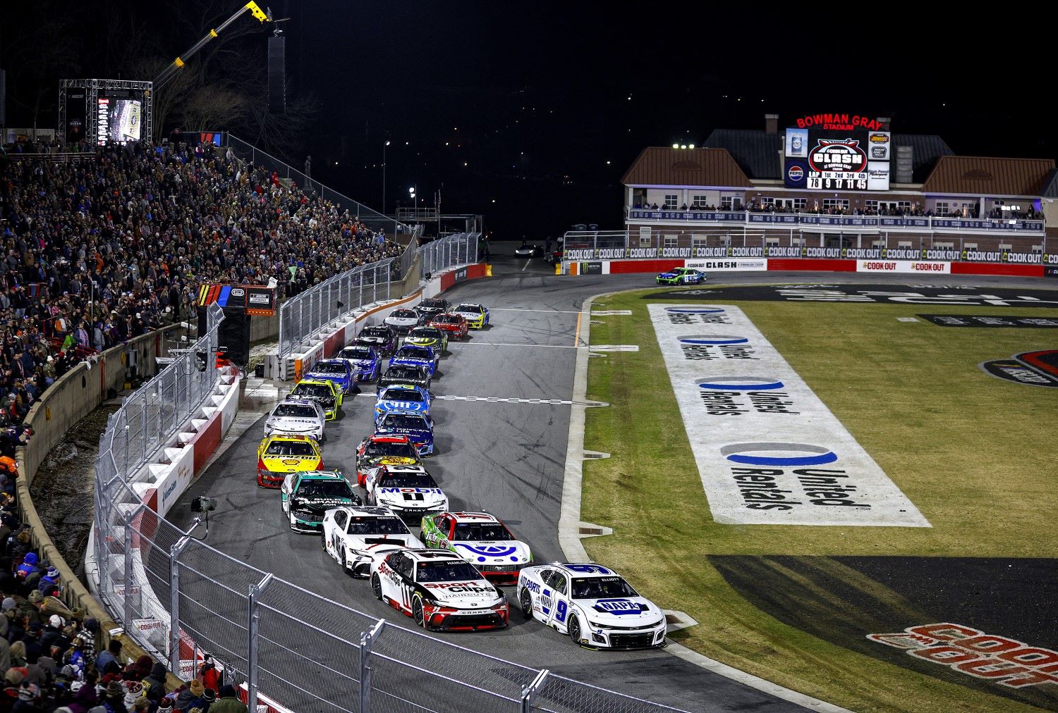 Chase Elliott, driver of the #9 NAPA Auto Parts Chevrolet and Denny Hamlin, driver of the #11 Sport Clips Haircuts Toyota lead the field during the Cook Out Clash at Bowman Gray Stadium on February 02, 2025 in Winston Salem, North Carolina. (Photo by Sean Gardner/Getty Images for NASCAR)