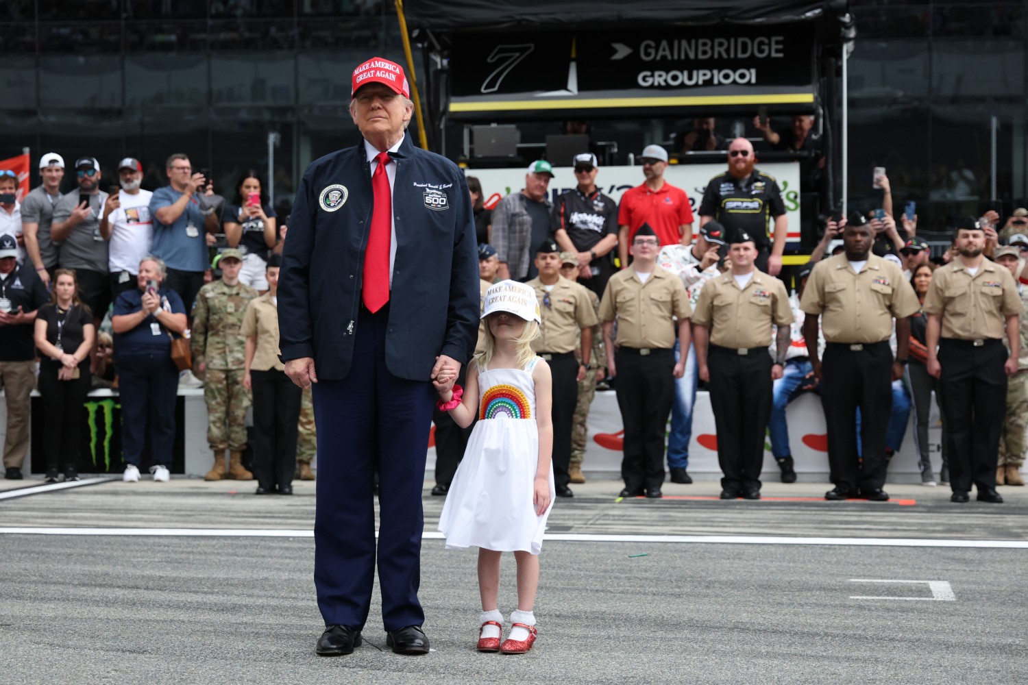 U.S. President Donald Trump stands on the grid during pre-race ceremonies prior to the NASCAR Cup Series Daytona 500 at Daytona International Speedway on February 16, 2025 in Daytona Beach, Florida. (Photo by Chris Graythen/Getty Images)